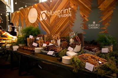 In Blueprint Studios’ lounge, a wood-paneled wall featured cutouts in the shape of pine trees. Elaine Bell Catering offered a variety of bacon-inspired treats, such as hard cider bacon brittle and spiced candied bacon bows.