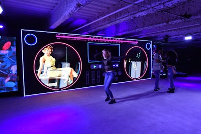 Giant boomboxes made with LED lighting came to life when guests pressed the play button, triggering lights, music, and the emergence of dancers who performed routines. They also housed a DJ booth in the “tape deck” part of the boombox, where DJ Myles Hendrik spun tunes for general admission guests.
