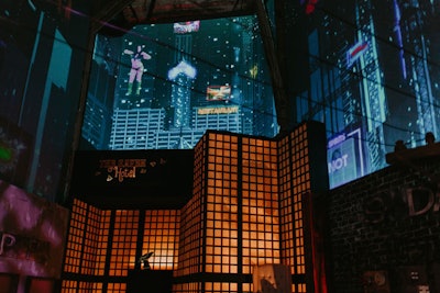 Projection mapping of Bay City buildings, twinkling lights, flashing signs, and gyrating dancers helped bring the fictional city to life within the walls of Mack Sennett Studios.