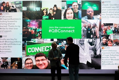 A social-media wall aggregated conversations with the conference hashtag #QBConnect.