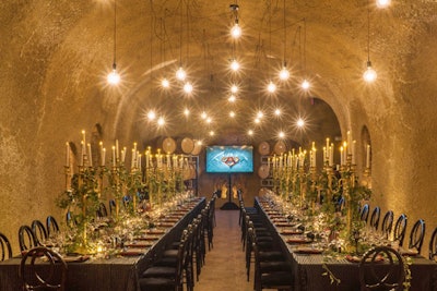 Clos Pegase has a wine cave that organizers transformed into the “Batcave” for the dinner portion of the evening. Tabletops were adorned with tall candelabras, trailing ivy on the tables (a wink to Batman villain Poison Ivy), leather-accented linens, and elegant place settings.