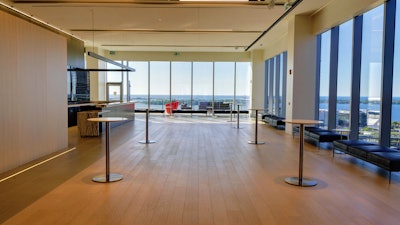 The south end of the lounge features a marble bar and entrance to the terrace.