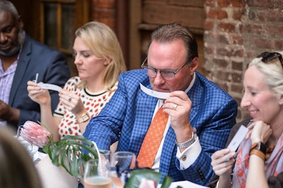 During the Virtual Visit to Bermuda luncheon in New York City, Randy Wilcott of Elbow Beach Bermuda samples one of Lili Bermuda’s alluring fragrances inspired by the island’s natural beauty.