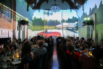 The four-course seated dinner was enhanced by animated wall projections that depicted various environments and scenarios inspired by the series, including a trip on a private plane.