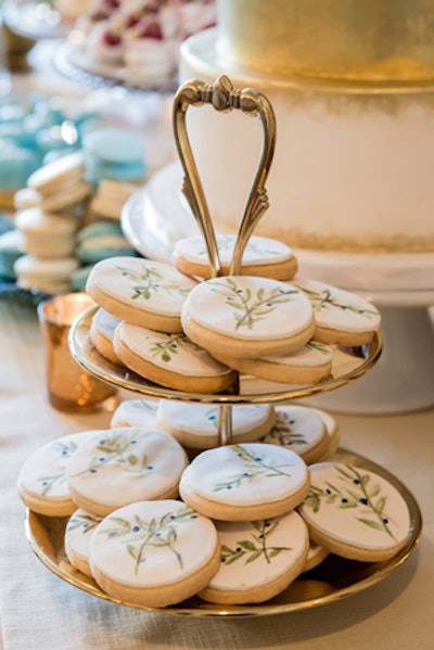 Hand-painted cookies were available on the dessert table; additional hand-painted cookies that said 'Love Is Sweet' were served as gifts at individual place settings.