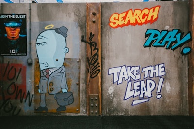 The maze challenges guests to find three “keys.” Staffers and wall graffiti remind attendees of the clues—“Search,” “Play,” and “Take the Leap.” All three keys must be found to unlock the door to the final room, which features original props from the film, plus a leaderboard displaying the users who completed the challenge the fastest.