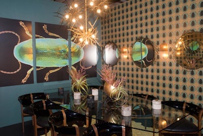 For its booth, Arteriors created a luxe, sexy aesthetic inspired by the scarab, a sacred status symbol that has been used in design for centuries. Custom wallpaper and a trippy triptych, along with black lacquer seating and branch-esque lighting fixtures, offered an edgy take on the nature theme.