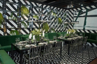 Crate and Barrel's signature black-and-white branding served as a backdrop for the company’s dining vignette. Lush green benches, chrome chairs, and fresh greenery brought the space to life.
