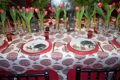 Designer Alessandra Branca interpreted Benjamin Moore’s color of the year—Caliente—into a tablescape with Moroccan arches, lanterns, patterned fabric and tableware, and tulips.