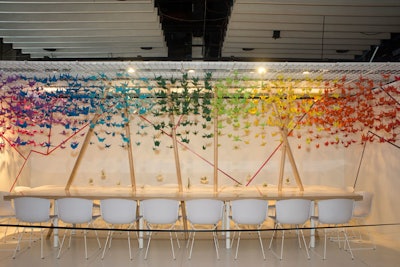 Design firm Gensler and Knoll's space featured a colorful rainbow of origami cranes suspended above a dining table.