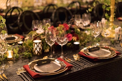 The tables featured leather-accented linens and a black, red, and gold color scheme.
