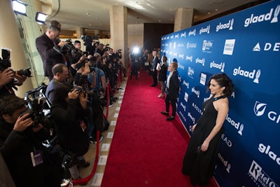 The red carpet at the Beverly Hilton had a blue step-and-repeat with sponsor names.