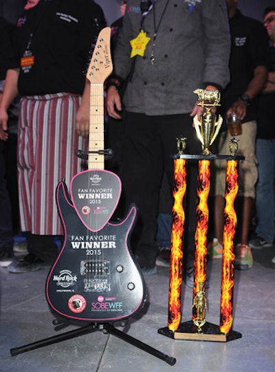 During the South Beach Wine & Food Festival in 2015, Guy Fieri hosted an event dubbed Meatopia. Fieri presented the winning trophies—a guitar for the fan favorite and a cow-topped trophy with flame accents as the judges' choice.