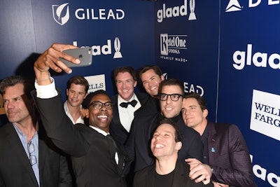 The sponsor integration continued backstage, where celebrities—such as surprise guests Andrew Rannells, Zachary Quinto, Matthew Bomer, and other members of Broadway's The Boys in the Band—could pose in front of a branded wall.