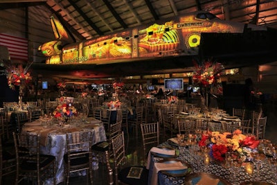 For the seated dinner, the museum’s Samuel Oschin Pavilion was transformed to resemble King Tut’s royal tomb. Video mapping from Bart Kresa Design masked the space shuttle Endeavour, turning it into the dining room’s focal point.