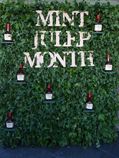 A wall of greenery studded with Maker's Mark bottles served as a backdrop for photos.