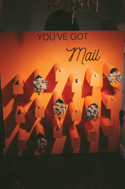 A wall with orange mailboxes offered guests invitations to the “bridal shower,” which was held in the next room.