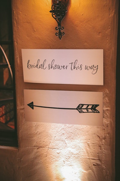 Black-and-white signage guided guests to different areas of the venue.