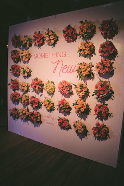 The “Something… New” photo wall was decorated with bouquets.