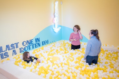 A Instagrammable pop-up isn't complete without a ball pit. The Egg House ball pit, naturally, is filled with white and yellow plastic balls.