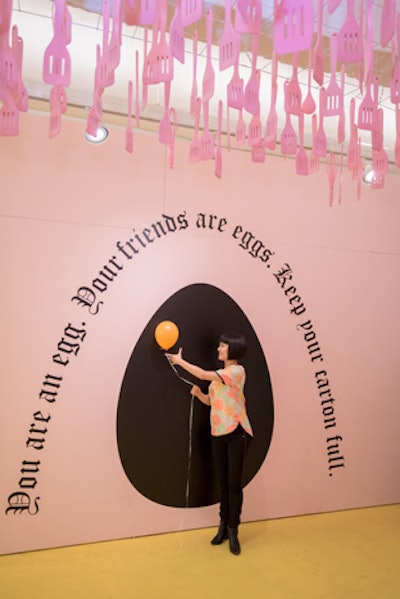 A painted wall displays the black silhouette of an egg along with a cheeky phrase: 'You are an egg. Your friends are eggs. Keep your carton full.'