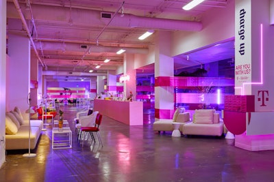The raw venue was transformed with colorful, modern furniture that created common space for guests to interact, relax, and get work done. Bright pink wrapping was used to separate the different areas of the event, and T-Mobile offered a spot for charging phones.