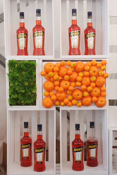 Bright colors from mounted greenery and oranges popped in the clean design of a bar from Aperol, which was located inside the Grand Tasting tent at the 2017 South Beach Wine & Food Festival in Miami.