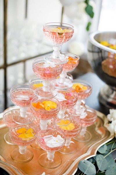 A rose or champagne tower of vintage crystal coupes stacked on top of a gilded tray and garnished with edible blooms was a reference to the iconic gardens of Windsor.