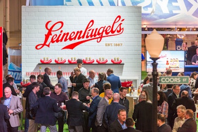Leinenkugel’s bar showcased the brand's red logo against a white brick wall. Cans of the light beer were displayed in mini inflated red canoes.