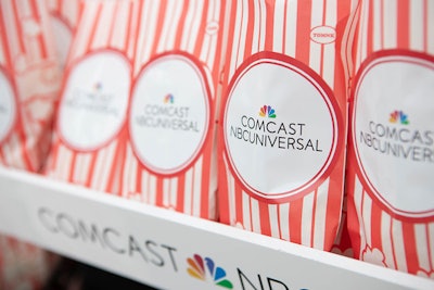 At Comcast’s cocktail reception, branded bags of popcorn, Junior Mints, and other sweet treats were available.