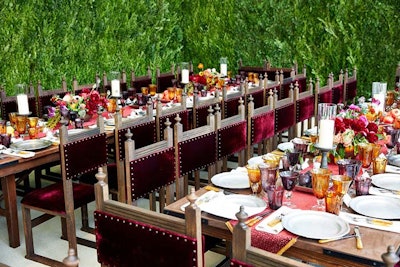 In lieu of linens, Avila decorated the surfaces with deeply hued flowers and fruit, all placed on a burgundy runner with gold tassels—a nod to the decadent feel of a last supper. The oak monastery chairs were custom made.