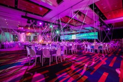 HMR Designs extended miles of ribbons from 125 points on the ceiling. As guests moved around the room, the angles intersected to create interesting, dynamic visuals.