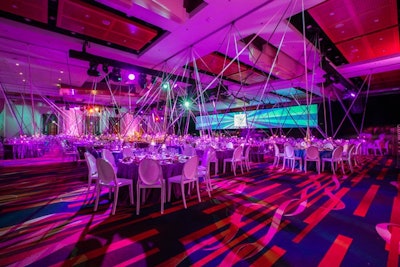 HMR Designs extended miles of ribbons from 125 points on the ceiling. As guests moved around the room, the angles intersected to create interesting, dynamic visuals.