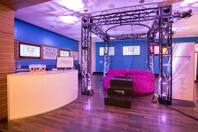 Moxy, which is known for having a fun, millennial-focused aesthetic, showcased a “Play On” area that featured a ball pit hanging from a truss cube. Guests were invited to jump in and search for prizes in the hot pink plastic balls. The station also had a bar that served cocktails in Capri Sun-inspired pouches.