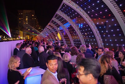 The Rainbow Bridge turned a 605-foot elevated pedestrian bridge that was literally a shortcut between areas of the convention center into newly activated event space. The design of the Rainbow Bridge, a “state-of-the-art” architectural structure, mimics a breaking wave and is illuminated by 3,500 customizable LED lights. The canopy of the breaking wave is illuminated and the length of the bridge is lit with nearly 100 downlights and landscape lights. An additional 70 LED floodlights make the Rainbow Bridge a colorfully attractive art piece.