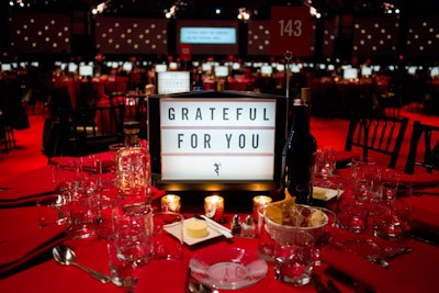 Three-sided mini marquee centerpieces offered messages of gratitude and celebrated the organization's 30th anniversary.