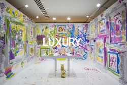 Guests were invited to take brushes and rollers to paint what they wanted on the walls. The word “luxury” was displayed on the back wall.