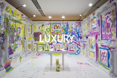 Guests were invited to take brushes and rollers to paint what they wanted on the walls. The word “luxury” was displayed on the back wall.