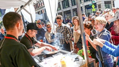 Festival attendees getting a close-up view during a chef demonstration