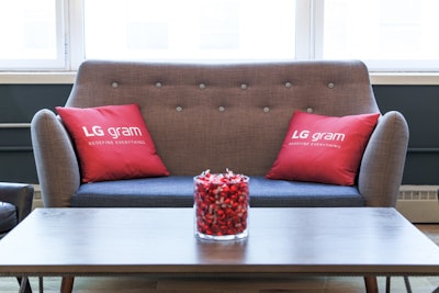 Couches and logo pillows furnished the space to create a comfortable setting.