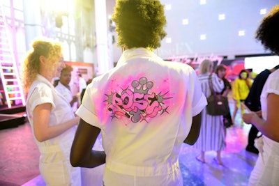 Staffers wore white jumpsuits that displayed a pink graffiti-style design of the series title.