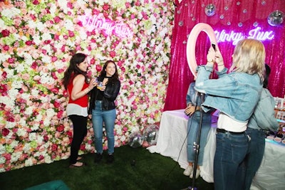 Winky Lux, a company that makes cosmetics inspired by magic, showcased a floral wall for photo ops.