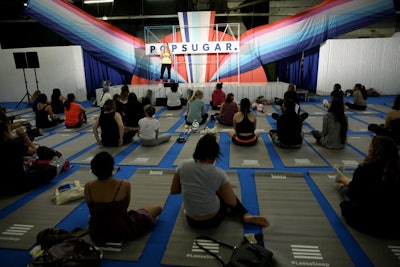 Attendees gathered at the festival stage for panel conversations and fitness sessions.