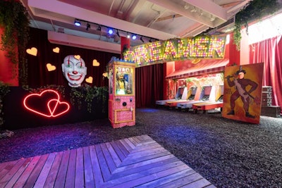 The colorful room—a purposeful contrast to the bright, all-white subway platform room—featured branded Skee-Ball, a Zoltar fortune-telling machine, and a giant clown mask.
