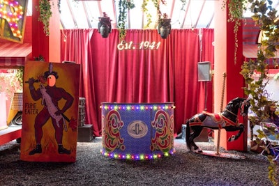 The entire experience incorporated Coach's signature 'C' into the decor in subtle ways, including at a blue DJ booth, which also featured an illustration of the brand's familiar handbag clasp. An illuminated sign displayed the year the brand was founded against red curtains, and other props included a carousel horse.