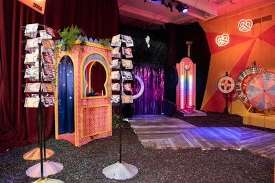 Another section of the room displayed neon pretzel decor, wheel-of-fortunes, a rainbow carnival high striker, and a photo booth with props.