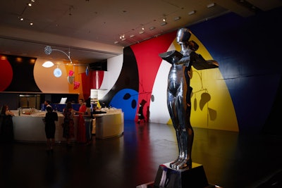 A lifesize version of Trova, the C.F.D.A. statue, stood on display during cocktails while giant colorful murals designed by Beckman and his team, in a nod to pop art, brought a jolt of vibrancy and energy into what are normally the coat check and visitor's desk areas.