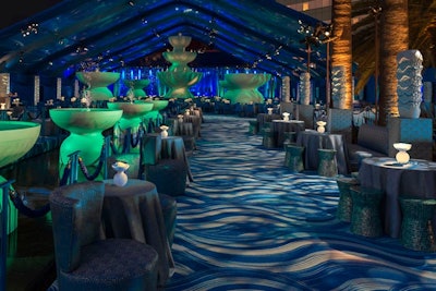 The same year, HBO’s annual post-Emmys party had a water theme. Designer Billy Butchkavitz used a color palette with seven shades of blue, and a 105-foot-long water lounge flowed from the dining pavilion to the formal entrance of the event space. Rippling water-patterned custom carpet covered the party space, and centerpieces were hand-blown glass pedestal bowls with floating dinnerplate dahlias, creating the look of a tabletop water garden.