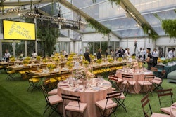 Inside the tented dining space, sections of round and rectangular dining tables were decorated in four distinct springtime shades—sunshine yellow, robin’s egg blue, rich teal, and cherry blossom pink.