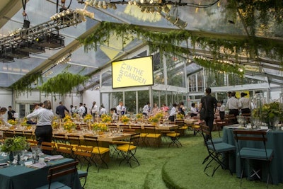 Greenery swags hung from the clear plastic tent’s trusses, and faux grass carpeting lined the space.